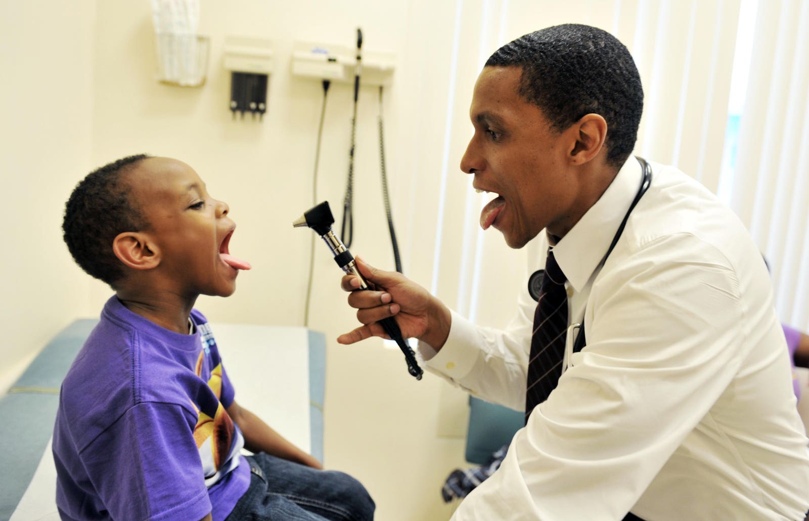 Doctor playfully examining a child during a checkup